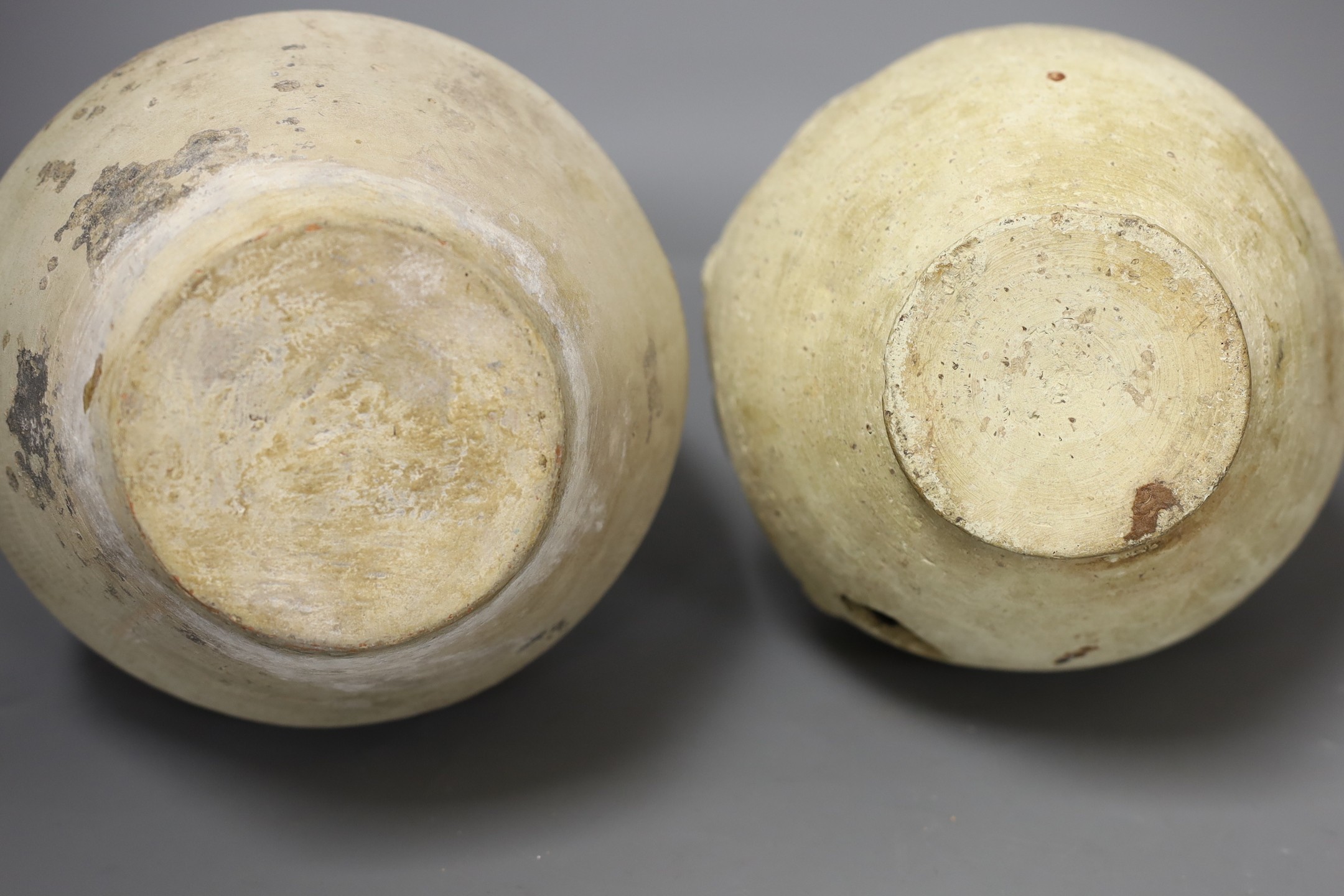 Three Islamic terracotta jugs and a strainer, Middle Eastern, possibly 12th century, tallest 24cm